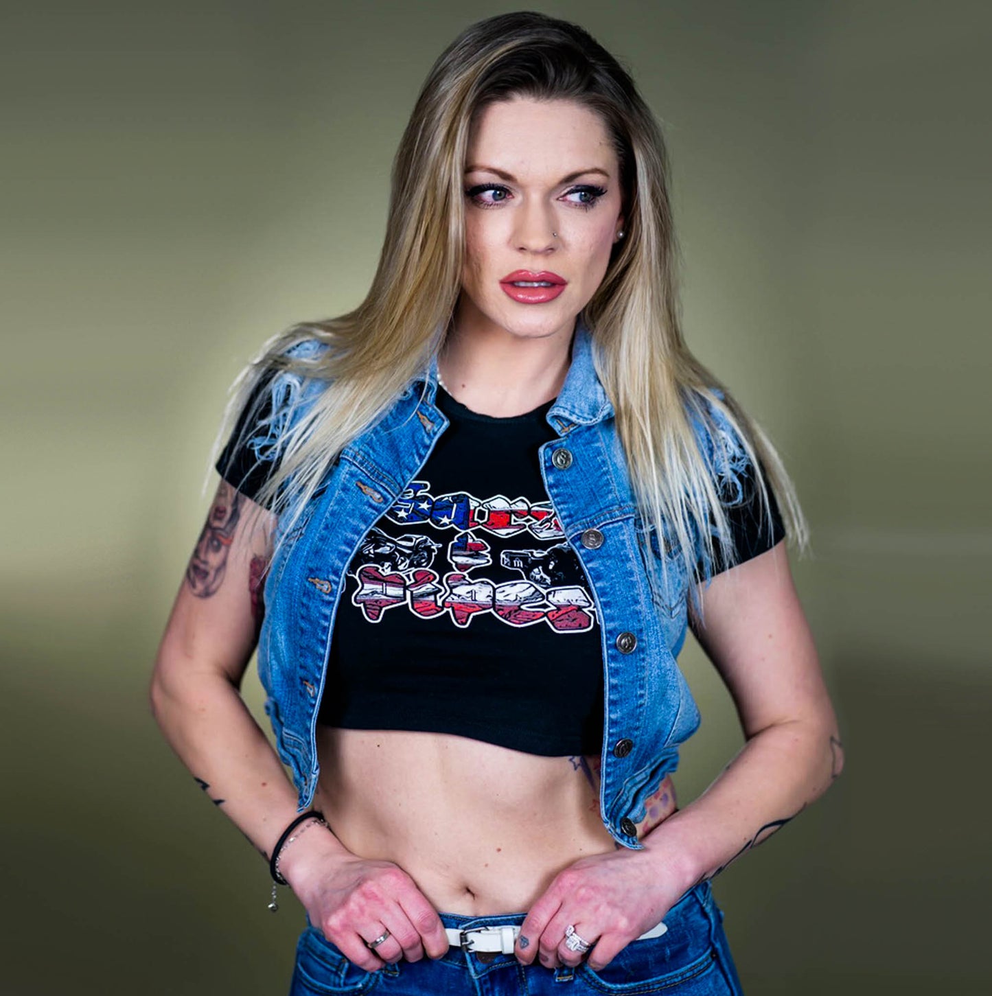 Blonde women wearing a Menace Clothing Bars & Pipes crop top in a jean jacket.