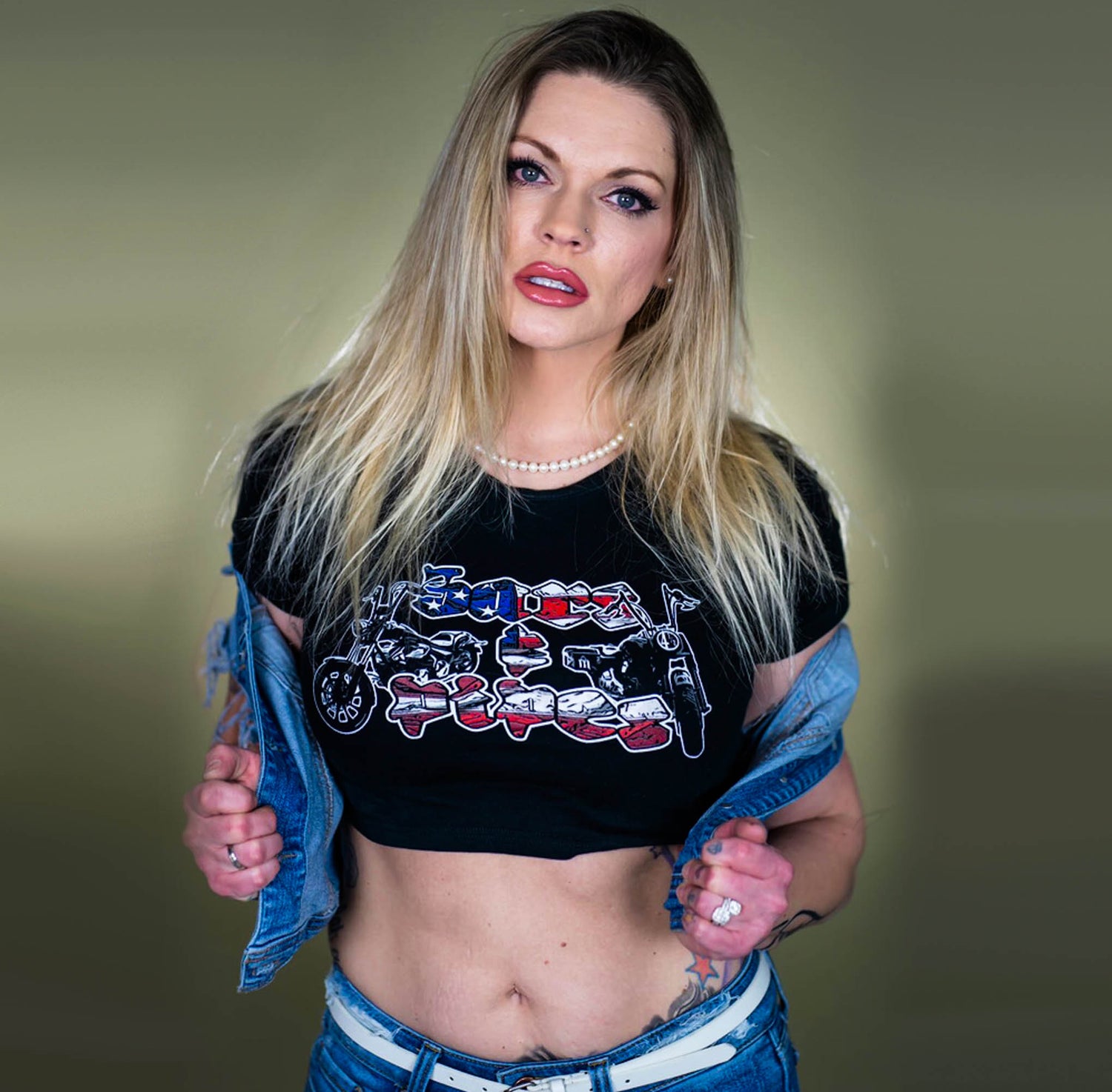 Blonde women wearing a Menace Clothing Bars & Pipes crop top in a jean jacket.