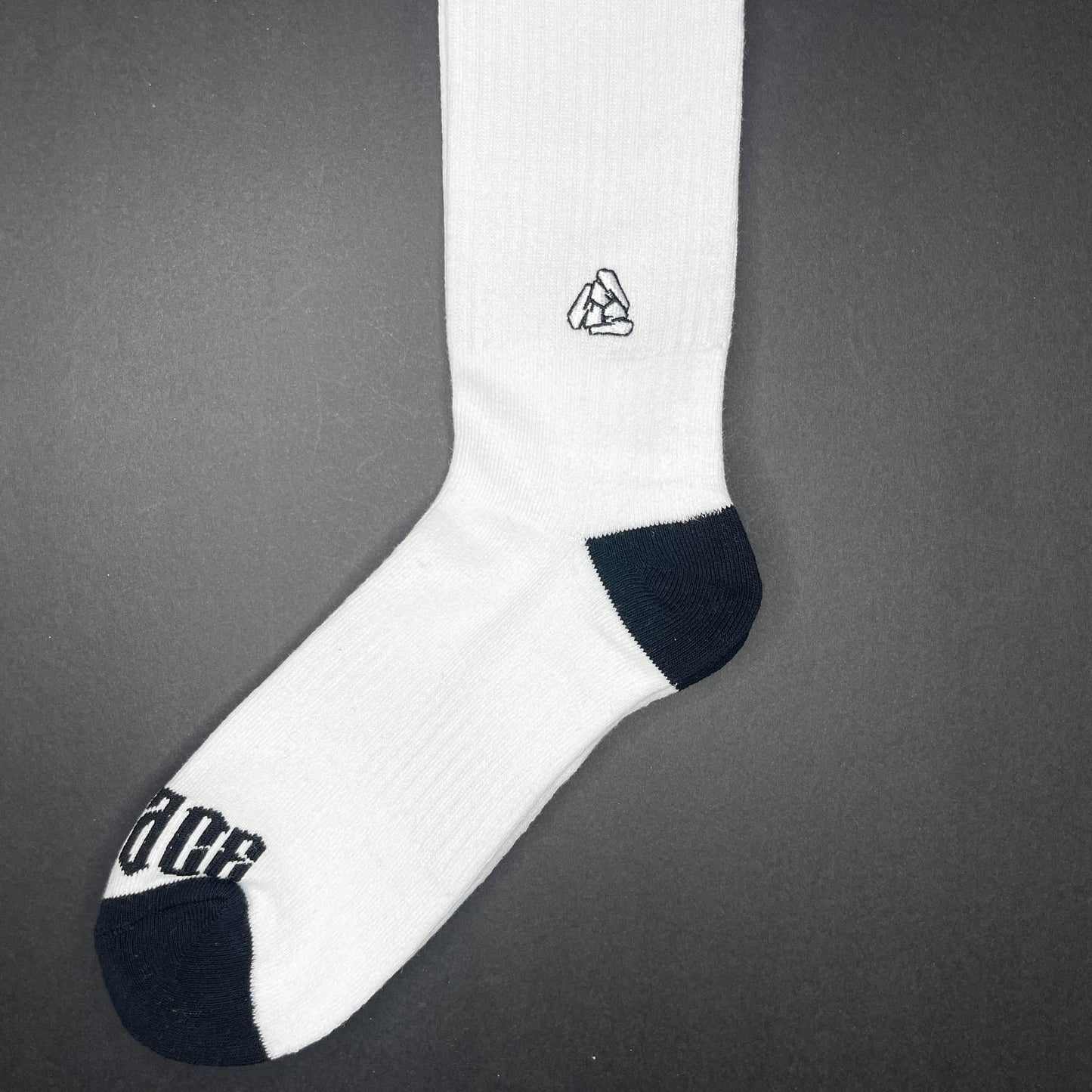 Side view of Menace Clothing Hood Rat black and white knee high socks with Menace on toes and Tri M logo on side.