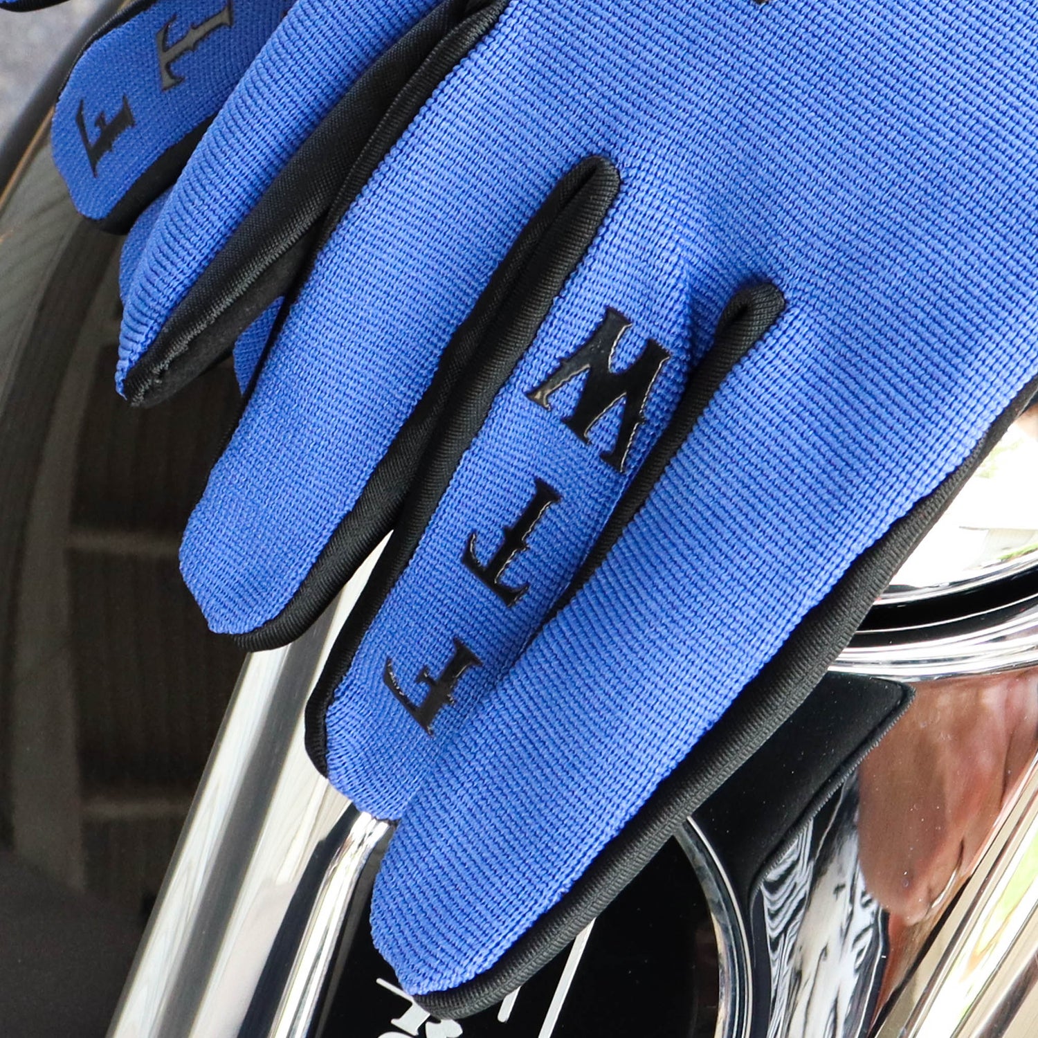 Menace Clothing’s blue FTW motorcycle gloves with FTW on middle finger.