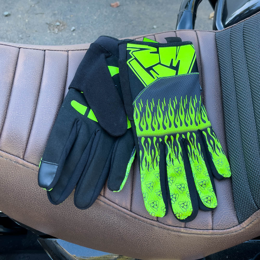 Green motorcycle gloves on motorcycle seat. Menace Mitts.