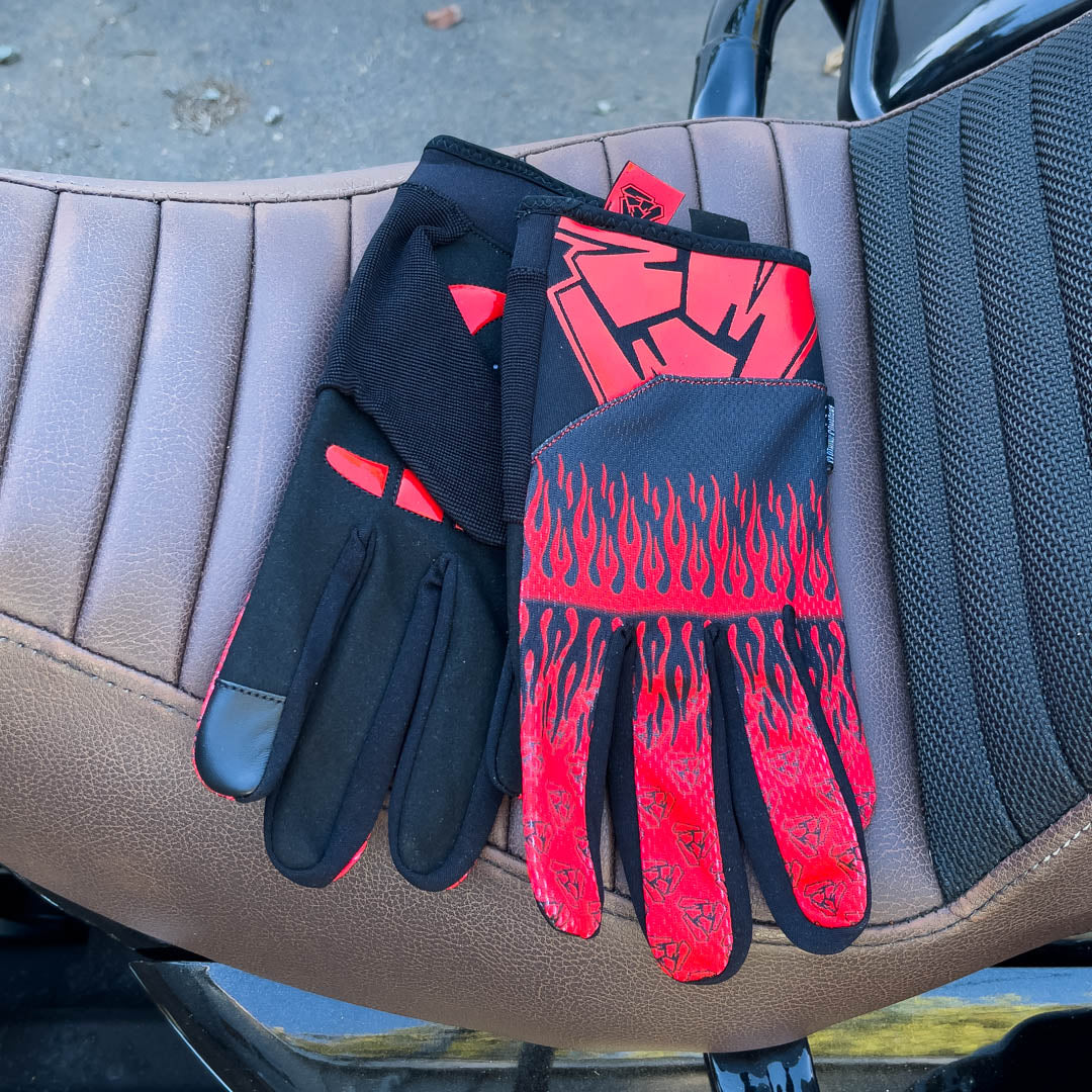 Red motorcycle gloves on motorcycle seat. Menace Mitts. 