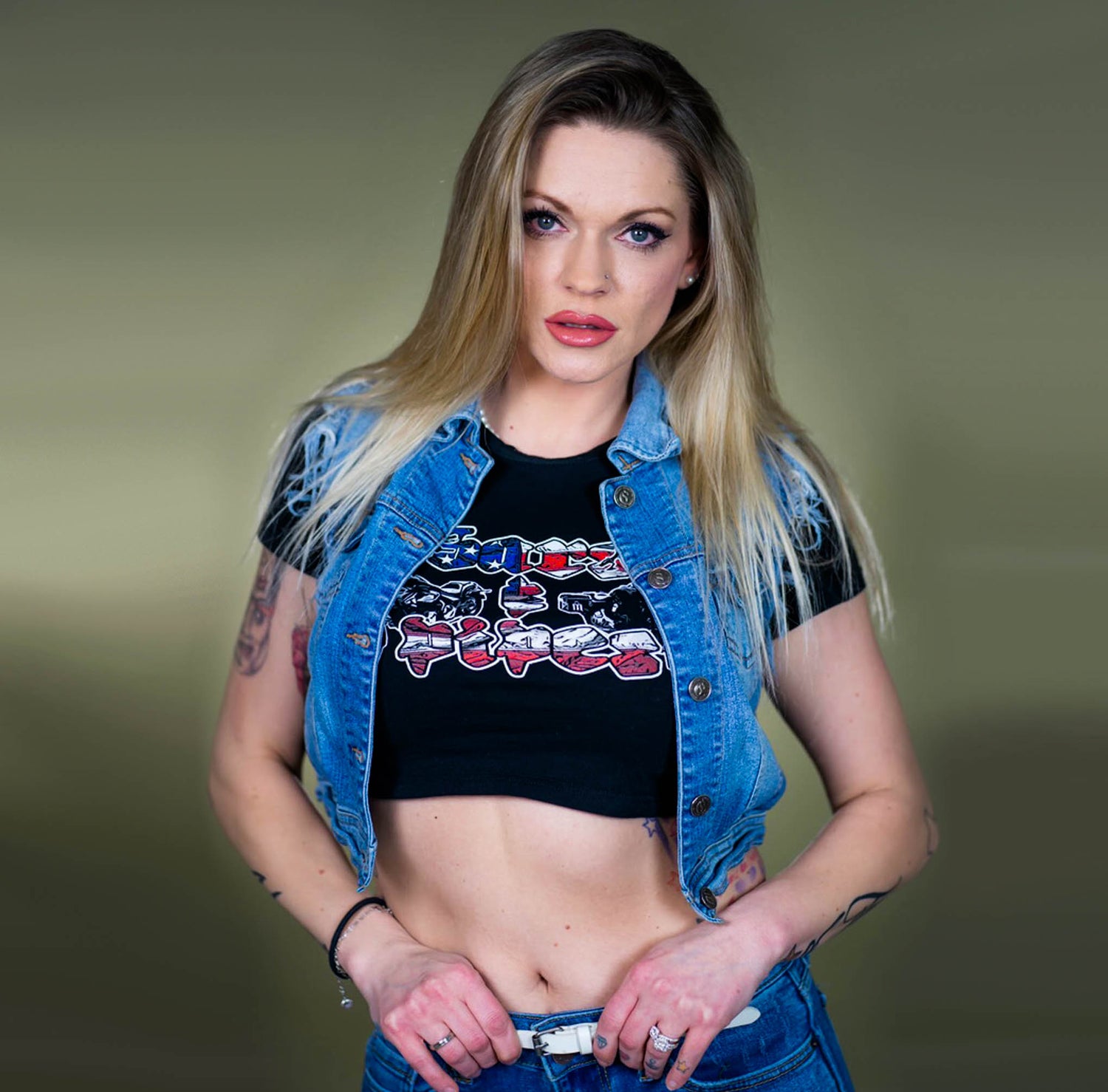 Blonde women wearing a Menace Clothing Bars & Pipes crop top in a jean jacket.