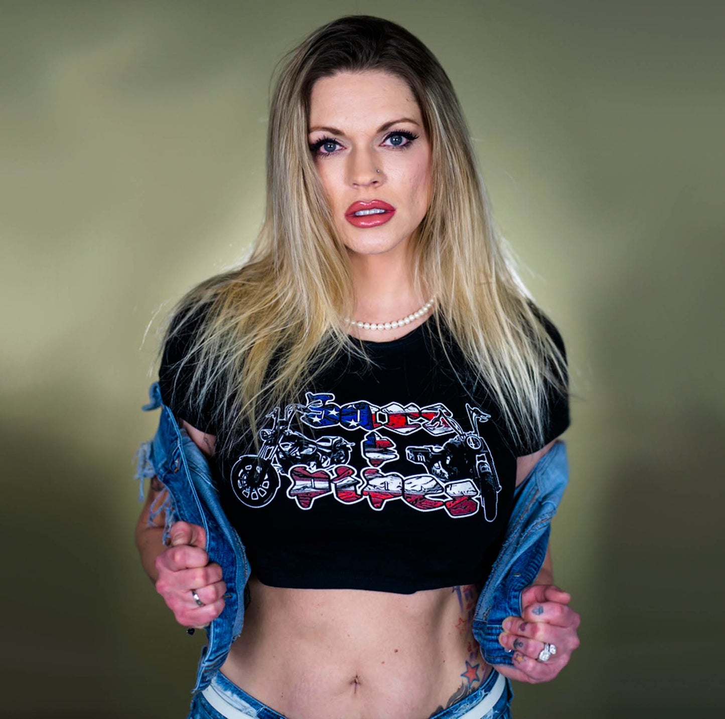 Blonde women wearing a Menace Clothing Bars & Pipes crop top in a jean jacket.