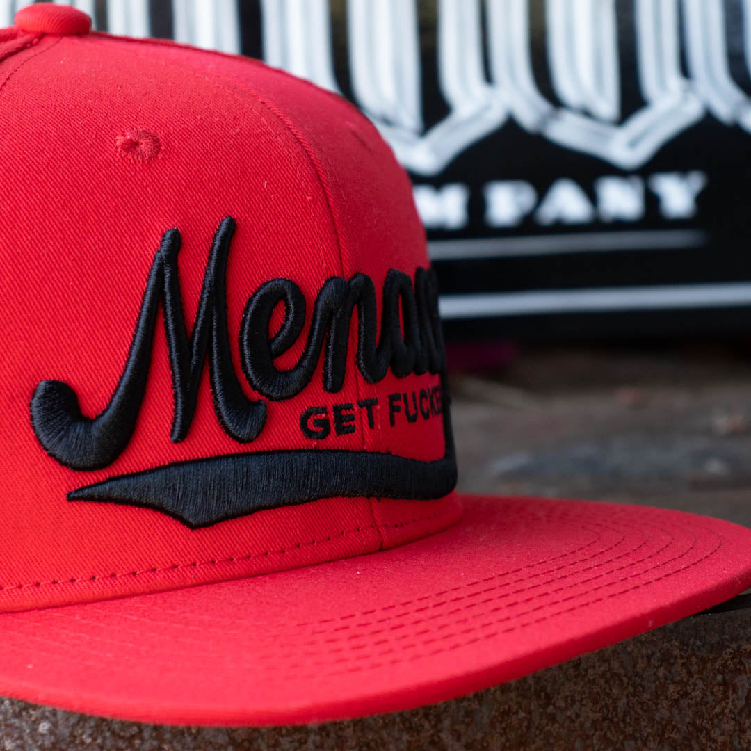 Close up of Menace Clothing embroidered red baseball hat. 