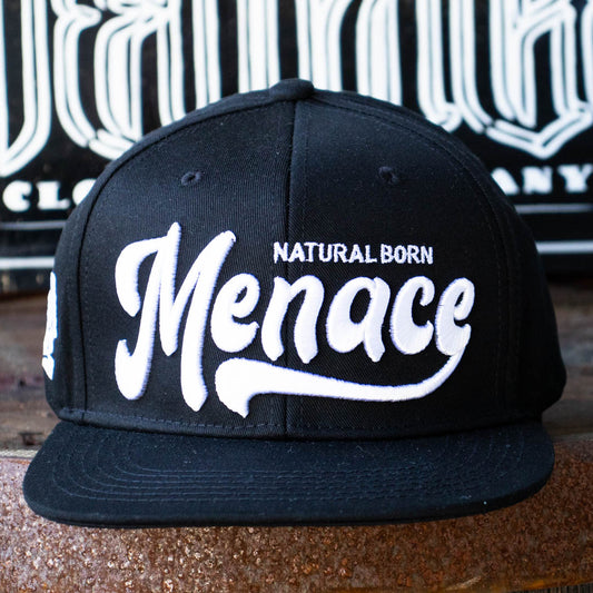 Front of Menace Clothing black baseball hat with white puff embroidered Natural Born Menace. 
