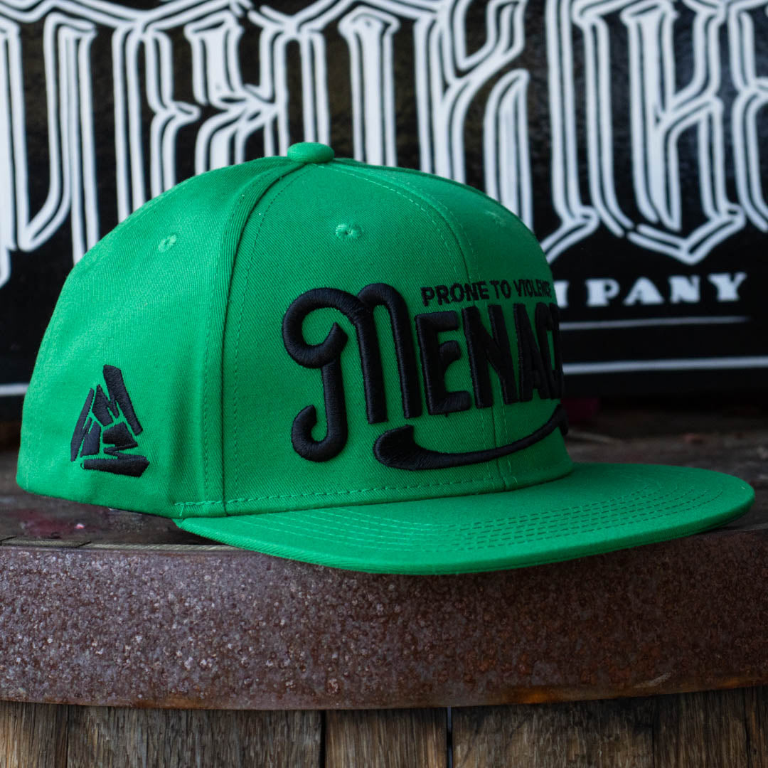 Right side of Menace Clothing green baseball hat with black puff embroidered saying Menace Prone To Violence.