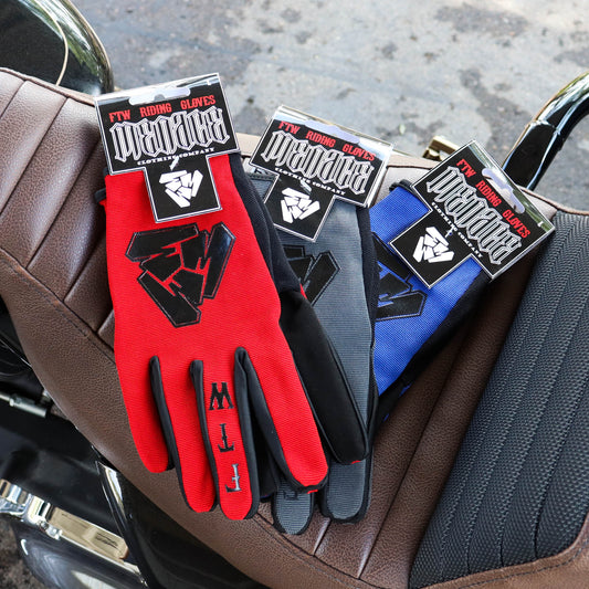 Menace Clothing’s red, gray, and blue FTW motorcycle gloves on motorcycle seat.